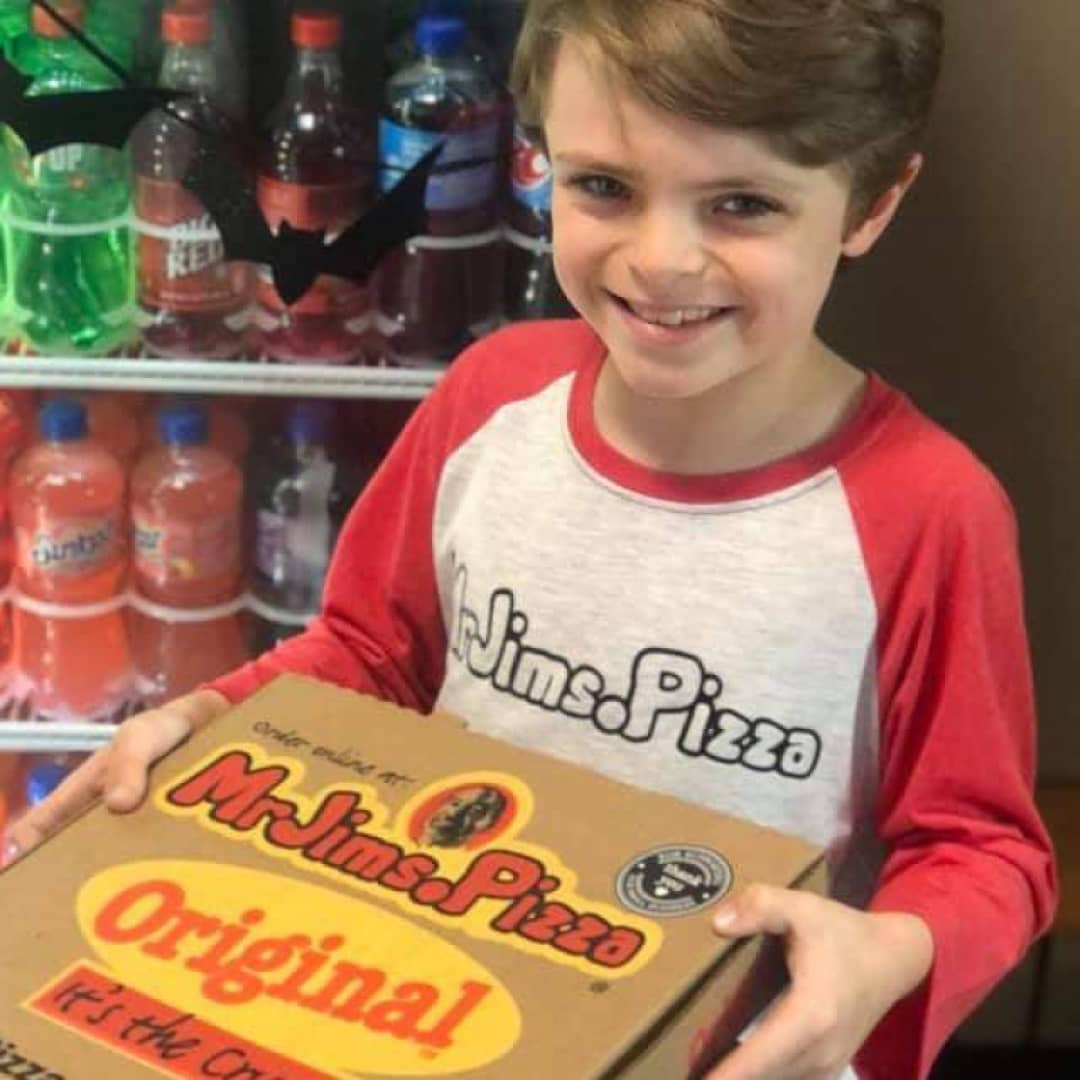 MrJims.Pizza - smiling child with pizza